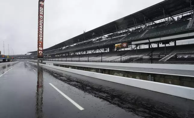 The scoring pylon is reflected on pit lane during a rain-delayed practice session for the Indianapolis 500 auto race at Indianapolis Motor Speedway, Tuesday, May 14, 2024, in Indianapolis. (AP Photo/Darron Cummings)