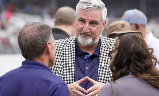 Indiana Governor Eric Holcomb has a conversation on pit lane before the Indianapolis 500 auto race at Indianapolis Motor Speedway in Indianapolis, Sunday, May 26, 2024. (AP Photo/AJ Mast)