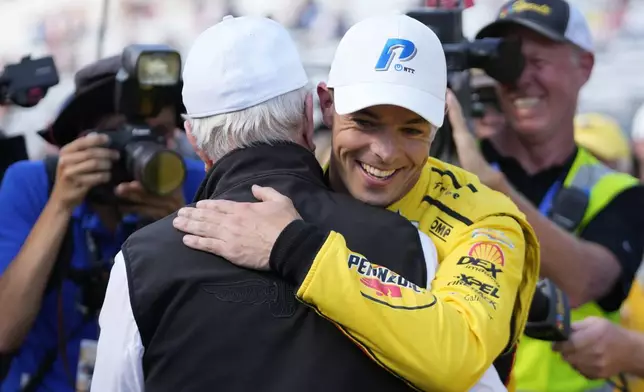 Scott McLaughlin, front right, of New Zealand, celebrates with Roger Penske, front left, after winning the pole for the Indianapolis 500 auto race at Indianapolis Motor Speedway, Sunday, May 19, 2024, in Indianapolis. (AP Photo/Darron Cummings)