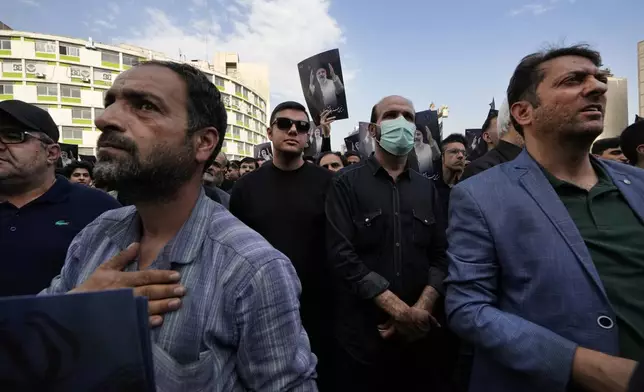 People attend a mourning ceremony for Iranian President Ebrahim Raisi, shown in the posters, at Vali-e-Asr square in downtown Tehran, Iran, Monday, May 20, 2024. President Raisi and the country's foreign minister were found dead Monday hours after their helicopter crashed in fog, leaving the Islamic Republic without two key leaders as extraordinary tensions grip the wider Middle East. (AP Photo/Vahid Salemi)