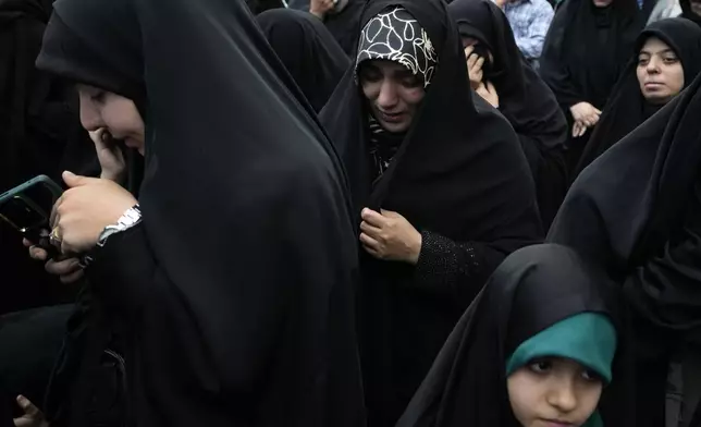 Women attend a mourning ceremony for Iranian President Ebrahim Raisi at Vali-e-Asr square in downtown Tehran, Iran, Monday, May 20, 2024. President Raisi and the country's foreign minister were found dead Monday hours after their helicopter crashed in fog, leaving the Islamic Republic without two key leaders as extraordinary tensions grip the wider Middle East. (AP Photo/Vahid Salemi)
