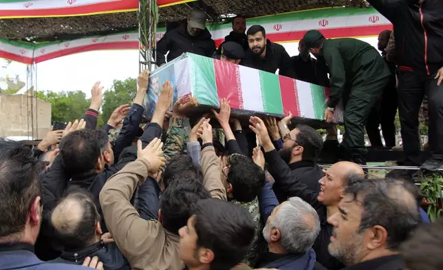 In this photo provided by Fars News Agency, mourners carry the flag-draped coffin of Iranian Foreign Minister Hossein Amirabdollahian, who was killed in a helicopter crash along with President Ebrahim Raisi on Sunday in a mountainous region of the country's northwest, during a funeral ceremony at the city of Tabriz, Iran, Tuesday, May 21, 2024. Mourners in black began gathering Tuesday for days of funerals and processions for Iran's late president, foreign minister and others killed in a helicopter crash, a government-led series of ceremonies aimed at both honoring the dead and projecting strength in an unsettled Middle East. (Ata Dadashi, Fars News Agency via AP)