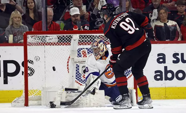 Carolina Hurricanes' Evgeny Kuznetsov (92) shoots a penalty shot puck past New York Islanders goaltender Semyon Varlamov (40) during the first period in Game 5 of an NHL hockey Stanley Cup first-round playoff series in Raleigh, N.C., Tuesday, April 30, 2024. (AP Photo/Karl B DeBlaker)