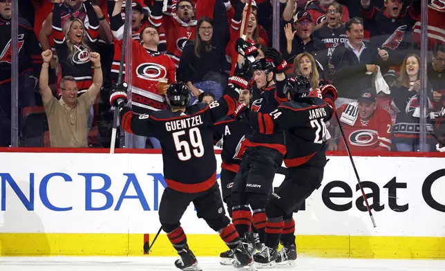 Carolina Hurricanes celebrate a goal by Andrei Svechnikov during the first period in Game 5 of an NHL hockey Stanley Cup first-round playoff series against the New York Islanders in Raleigh, N.C., Tuesday, April 30, 2024. (AP Photo/Karl B DeBlaker)