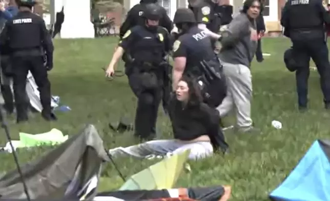 Police detain protesters as they take down tents at the University of Virginia on Saturday, May 4, 2024 in Charlottesville, Va. (WVAW via AP)