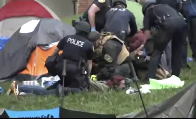 Police take down tents and detain protesters from at the University of Virginia on Saturday, May 4, 2024 in Charlottesville, Va. (WVAW via AP)