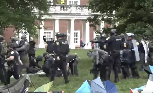 Police take down tents and detain protesters at the University of Virginia on Saturday, May 4, 2024 in Charlottesville, Va. (WVAW via AP)