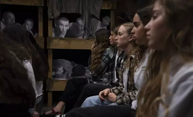 Israeli students listen to a lecture at the Testimony House, a Holocaust museum in Nir Galim, Israel, on the eve of Israel's annual Holocaust Remembrance Day, Sunday, May 5, 2024. Israel holds the day of remembrance each year to remember the six million Jewish victims of the Nazi genocide during World War II. (AP Photo/Oded Balilty)