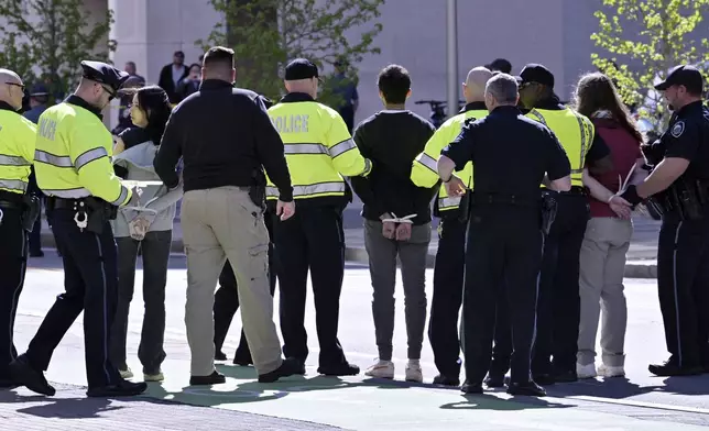 Police detain three a pro-Palestinian demonstrators who attempted to block traffic to the garage of the Stata Center at MIT, Thursday, May 9, 2024, in Cambridge, Mass. (AP Photo/Josh Reynolds)