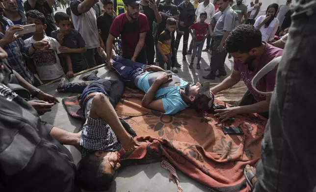 Palestinians killed in the Israeli bombardment of the Gaza Strip are brought to the Al Aqsa hospital in Deir al Balah, central Gaza Strip, on Monday, May 27, 2024. (AP Photo/Abdel Kareem Hana)