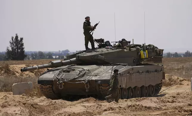 Israeli soldiers are seen near the border with the Gaza Strip, in southern Israel, Tuesday, May 7, 2024. (AP Photo/Tsafrir Abayov)