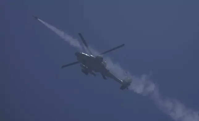 An Israeli Apache helicopter fires a missile towards the Gaza Strip, as seen from southern Israel, Thursday, May 16, 2024. (AP Photo/Leo Correa)