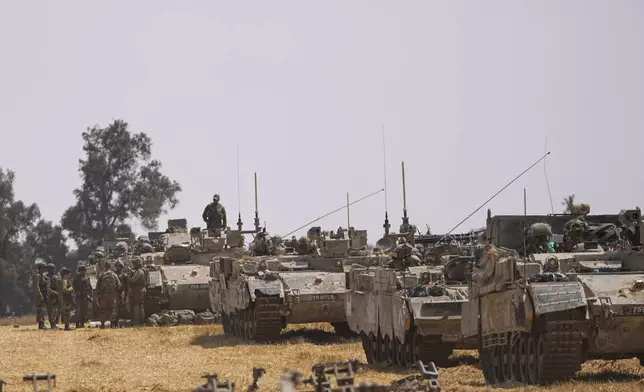 Israeli soldiers are seen at a staging ground near the border with the Gaza Strip, in southern Israel, Wednesday, May 1, 2024. (AP Photo/Ohad Zwigenberg)