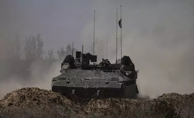 Israeli soldiers move on armored personnel carriers (APC) near the Israeli-Gaza border, in southern Israel, Wednesday, May 8, 2024. (AP Photo/Tsafrir Abayov)