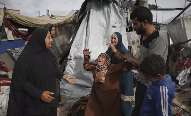 Displaced Palestinians inspect their tents destroyed by Israel's bombardment, adjunct to an UNRWA facility west of Rafah city, Gaza Strip, Tuesday, May 28, 2024. (AP Photo/Jehad Alshrafi)