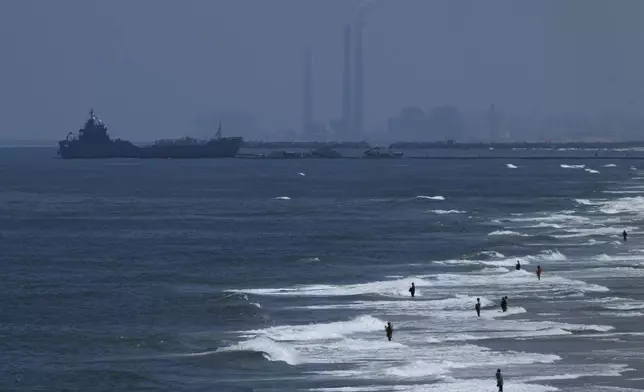 A ship is seen off the coast of Gaza near a U.S.-built floating pier that will be used to facilitate aid deliveries, as seen from the central Gaza Strip, Thursday, May 16, 2024. (AP Photo/Abdel Kareem Hana)