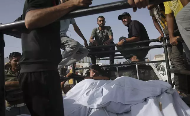 Palestinians transport the bodies of their relatives killed in an Israeli bombardment where displaced people were staying in Rafah, Gaza Strip, Tuesday, May 28, 2024. (AP Photo/Jehad Alshrafi)