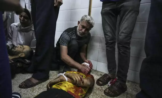 Palestinians mourn their relatives killed in the Israeli bombardment of the Gaza Strip, at the Al Aqsa hospital in Deir al Balah, Gaza, Thursday, May 9, 2024. (AP Photo/Abdel Kareem Hana)