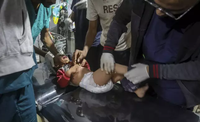 A Palestinian child wounded in the Israeli bombardment of the Gaza Strip is brought to a hospital in Rafah, Gaza, Friday, May 10, 2024. (AP Photo/Ismael Abu Dayyah)