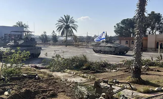 This photo provided by the Israel Defense Forces shows a tank with an Israel flag on it entering the Gazan side of the Rafah border crossing on Tuesday, May 7, 2024. (Israel Defense Forces via AP)