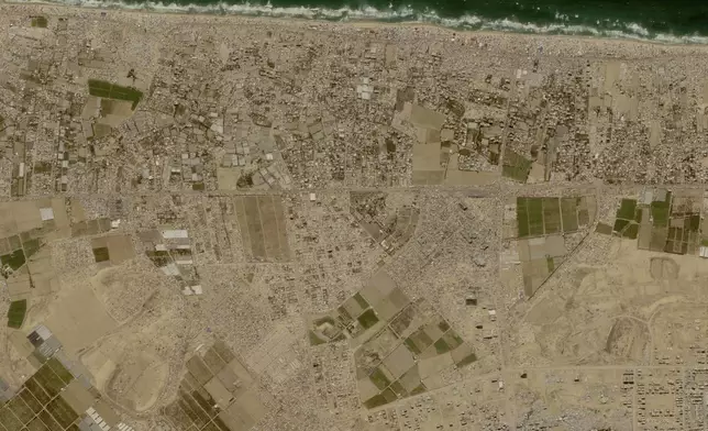 This image provided by Planet Labs PBC shows tent camps line the beach and fill empty lots outside the central Gaza city of Khan Younis, Friday, May 24, 2024, housing Palestinians who fled Israel's offensive in Rafah the past three weeks. (Planet Labs PBC via AP)