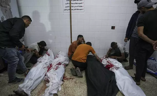 Palestinians react next to the bodies of their relatives who were killed in an Israeli airstrike in Gaza Stirp, at the Al Aqsa hospital in Deir al Balah, Gaza, Sunday, May 5, 2024. (AP Photo/Abdel Kareem Hana)