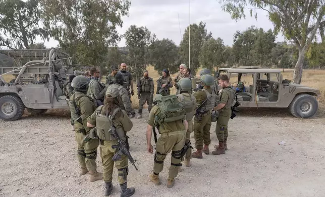 Israeli soldiers gather near the Israeli-Gaza border in southern Israel before they enter Gaza Strip, Wednesday, May 1, 2024. (AP Photo/Ohad Zwigenberg)