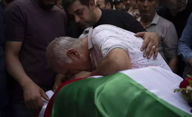 Palestinians mourns over the body of the doctor Ossayed Kamal Jabareen, at the government hospital in the West Bank city of Jenin, Thursday, May 23, 2024. The Israeli military said Thursday it has completed a two-day operation in the occupied West Bank that the Palestinian Health Ministry says killed 12 Palestinians. Militant groups claimed at least eight of the dead as fighters, one from Hamas and seven from the Al-Aqsa Martyrs Brigade. (AP Photo/Leo Correa)