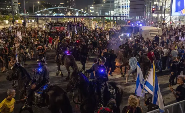 Police use horses to disperse demonstrators during a protest against Israeli Prime Minister Benjamin Netanyahu's government, and calling for the release of hostages held in the Gaza Strip by the Hamas militant group, in Tel Aviv, Israel, Sunday, May 26, 2024. (AP Photo/Ariel Schalit)
