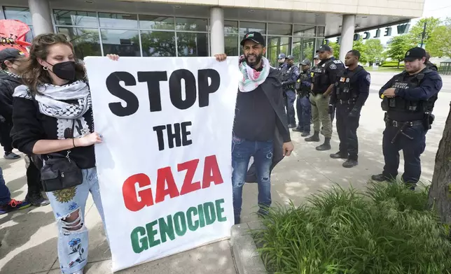 Pro-Palestinian protesters protest as Detroit Police look on during a visit by Vice President Kamala Harris in Detroit, Monday, May 6, 2024. (AP Photo/Paul Sancya)