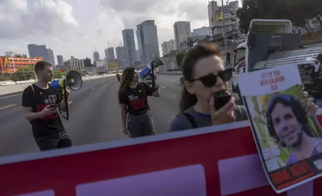 Activists block a highway as they demand the release of the hostages from Hamas captivity in the Gaza Strip, in Tel Aviv, Israel, Thursday, May 2, 2024. (AP Photo/Ohad Zwigenberg)