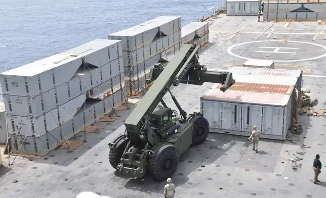 In this image provided by the U.S. Army, soldiers assigned to the 7th Transportation Brigade (Expeditionary) and sailors attached to the MV Roy P. Benavidez assemble the Roll-On, Roll-Off Distribution Facility (RRDF), or floating pier, off the shore of Gaza in the Mediterranean Sea on April 26, 2024. The pier is part of the Army's Joint Logistics Over The Shore (JLOTS) system which provides critical bridging and water access capabilities. (U.S. Army via AP)