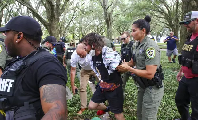 Law enforcement officers arrest a protester after clearing an "unlawful assembly" where pro-Palestinian protesters congregated at MLK Plaza at the University of South Florida on Tuesday, April 30, 2024, in Tampa, Fla. (Douglas R. Clifford/Tampa Bay Times via AP)