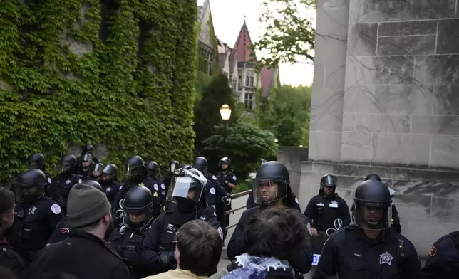Police block pro-Palestinian protesters from returning to their encampment as the encampment is dismantled at the University of Chicago, Tuesday, May 7, 2024. (AP Photo/Charles Rex Arbogast)