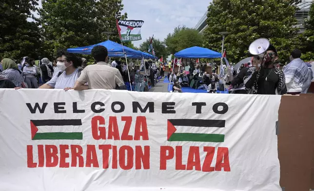People gather to protest against the Israel-Hamas war at a plaza at the University of Texas at Dallas, Wednesday, May 1, 2024, in Richardson, Texas. (AP Photo/LM Otero)