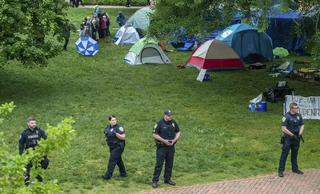 Police form a line where pro-Palestinian protesters set up tents on the grounds of the University of Virginia, in Charlottesville, Va., Saturday, May 4, 2024. (Cal Cary/The Daily Progress via AP)