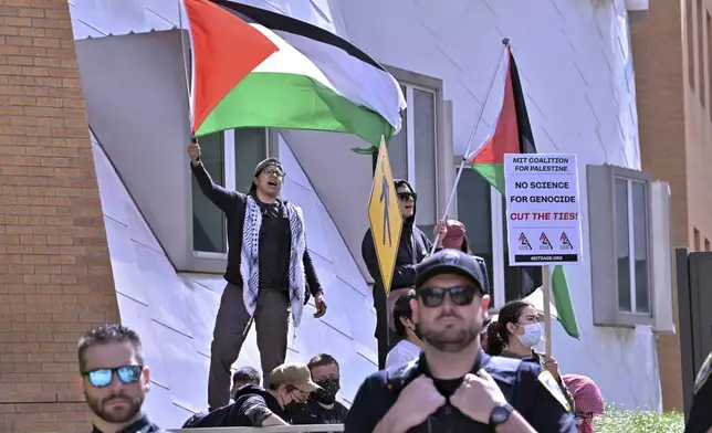 Pro-Palestinian demonstrators wave flags outside the Stata Center at MIT, Thursday, May 9, 2024, in Cambridge, Mass. (AP Photo/Josh Reynolds)