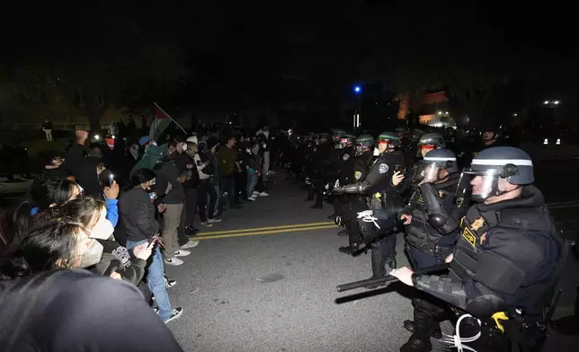 Police advance on demonstrators on the UCLA campus Thursday, May 2, 2024, in Los Angeles. (AP Photo/Ryan Sun)