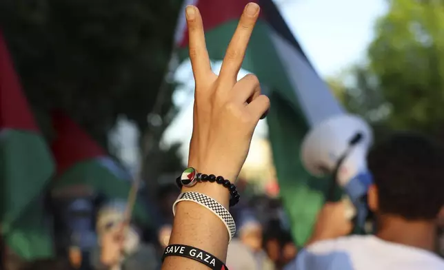 A pro-Palestinian protester holds up a peace sign during a march on the campus of St. Louis University, Wednesday, May 1, 2024, in St. Louis. (David Carson/St. Louis Post-Dispatch via AP)