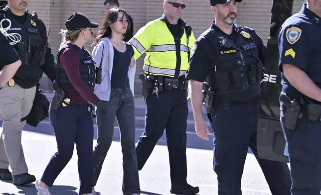 Police detain a pro-Palestinian demonstrator who attempted to block traffic from the garage of the Stata Center at MIT, Thursday, May 9, 2024, in Cambridge, Mass. (AP Photo/Josh Reynolds)