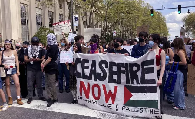 Pro-Palestinian protestors stand on Massachusetts Avenue near a student encampment on the campus of the Massachusetts Institute of Technology, after a 2:30pm deadline passed to leave the encampment, Monday May 6, 2024, in Cambridge, Mass. (AP Photo/Steve LeBlanc)