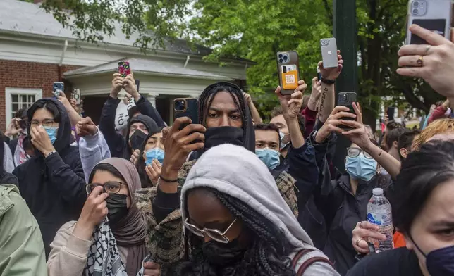 Pro-Palestinian demonstrators take videos and photos with their phones on the University of Virginia campus as police break up what authorities called an "unlawful assembly," in Charlottesville, Va., where tents are set up, Saturday, May 4, 2024. (Cal Cary/The Daily Progress via AP)