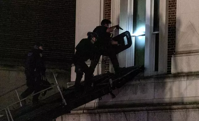 Using a tactical vehicle, New York City police enter an upper floor of Hamilton Hall on the Columbia University campus in New York Tuesday, April 30, 2024, after a building was taken over by protesters earlier Tuesday. Hundreds of police officers swept into Columbia University on Tuesday night to end a pro-Palestinian occupation of an administration building and sweep away a protest encampment, acting after the school’s president said there was no other way to ensure safety and restore order on campus. (AP Photo/Craig Ruttle)