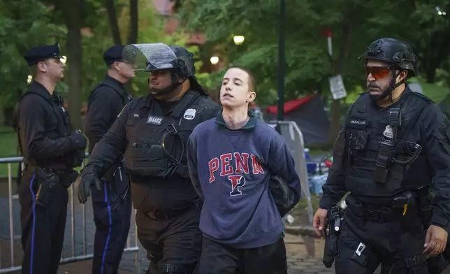 Police detain a protester on the University of Pennsylvania campus, in Philadelphia, on Friday, May 10, 2024. (Jessica Griffin/The Philadelphia Inquirer via AP)
