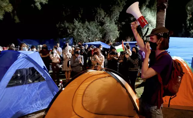 An organizer speaks to an encampment of pro-Palestinian demonstrators preparing to face off with law enforcement on the University of Arizona campus, Friday, May 10, 2024, Tucson, Az. (Kelly Presnell/Arizona Daily Star via AP)