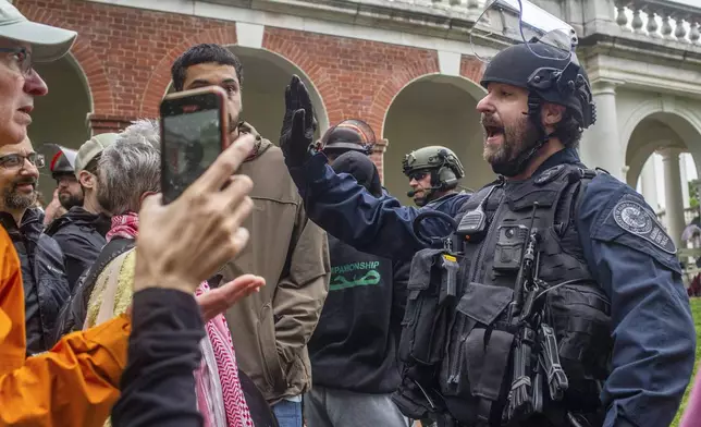 Police move pro-Palestinian demonstrators back from the grounds of the University of Virginia, in Charlottesville, Va., where tents are set up, Saturday, May 4, 2024. (Cal Cary/The Daily Progress via AP)