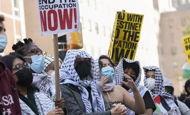 Protesters demonstrate against the war in Gaza outside the entrance to the campus of Columbia University, Tuesday, April 30, 2024, in New York. (AP Photo/Mary Altaffer)