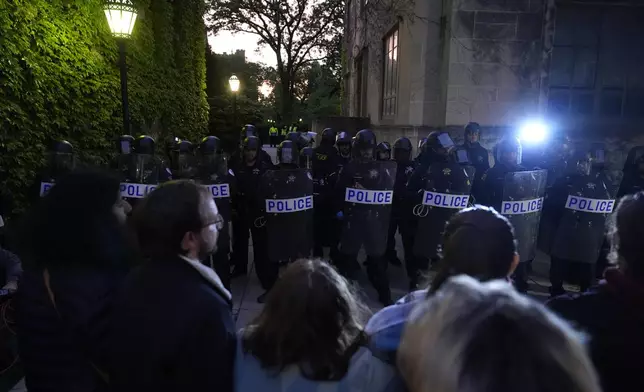 Police block pro-Palestinian protesters from returning to their encampment as the encampment is dismantled at the University of Chicago, Tuesday, May 7, 2024. (AP Photo/Charles Rex Arbogast)