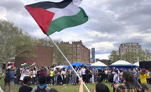 Pro-Palestinian protestors link arms and take back a student encampment on the campus of the Massachusetts Institute of Technology, after a 2:30pm deadline passed to leave the encampment, Monday May 6, 2024, in Cambridge, Mass. (AP Photo/Steve LeBlanc)
