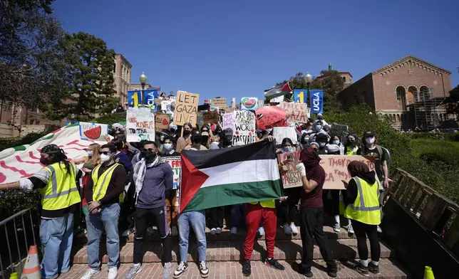Demonstrators gather on the UCLA campus, after nighttime clashes between Pro-Israel and Pro-Palestinian groups, Wednesday, May 1, 2024, in Los Angeles. (AP Photo/Jae C. Hong)